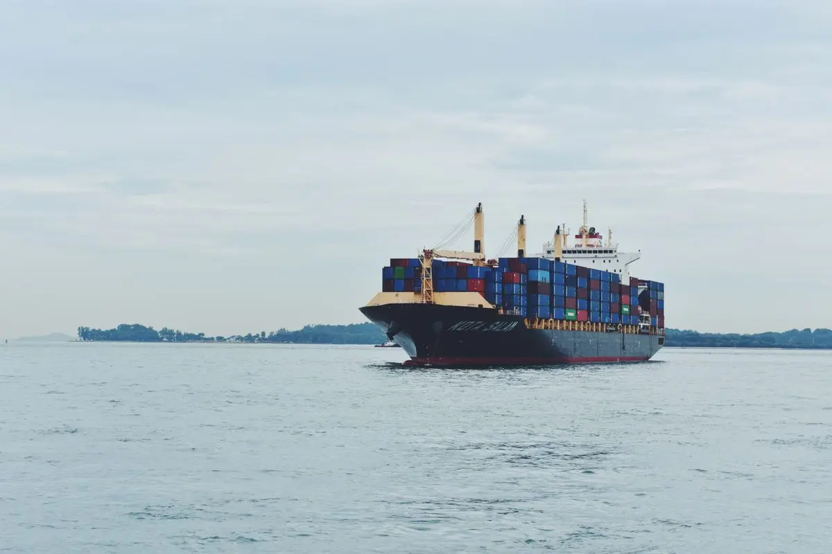A cargo ship transporting containers across open sea