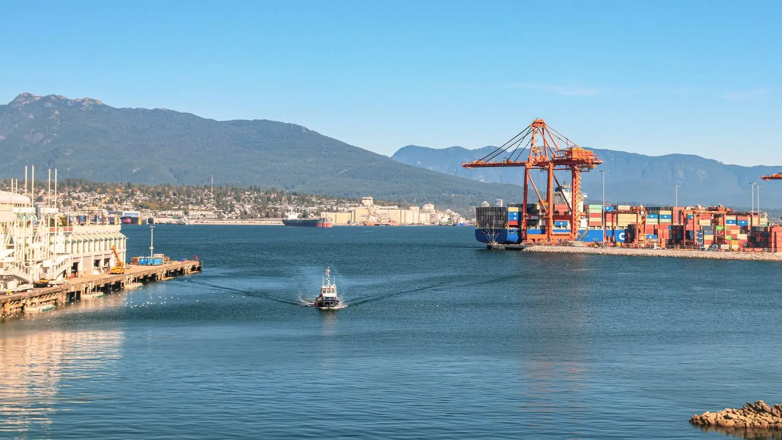 The Port of Vancouver, Canada, with quayside cranes and the coastal mountains behind