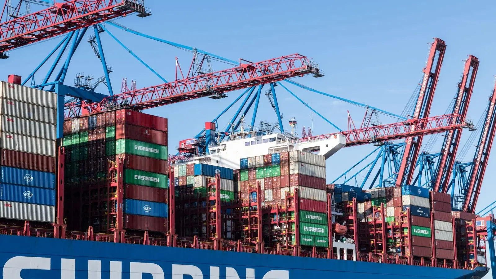 Stacked containers and gantry cranes at the Port of Hamburg