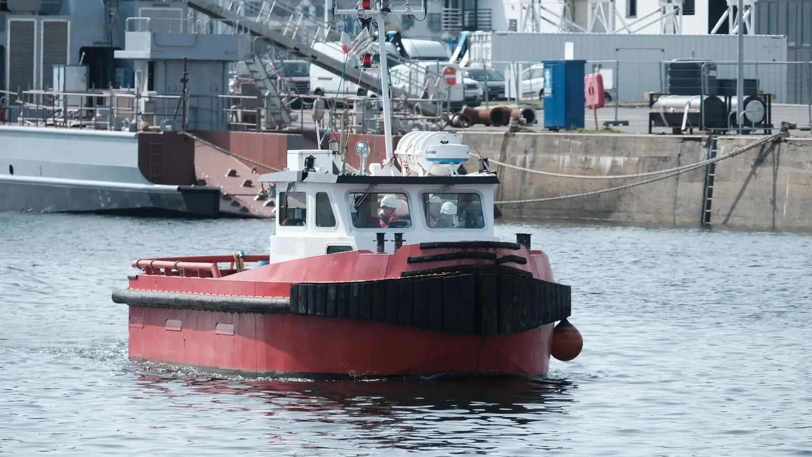 A tugboat working in the approaches to a commercial harbour