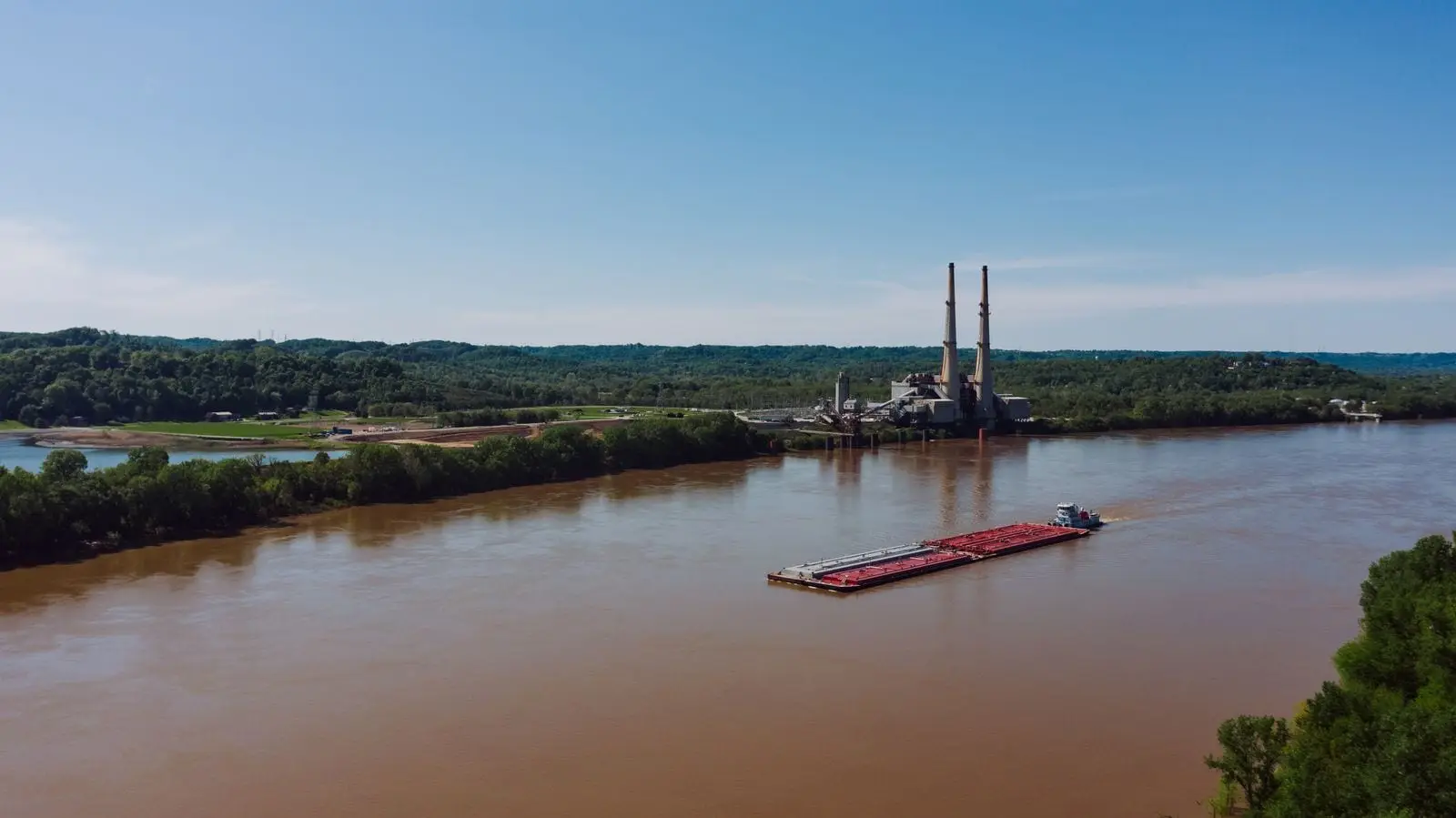 A barge carrying containers along a river