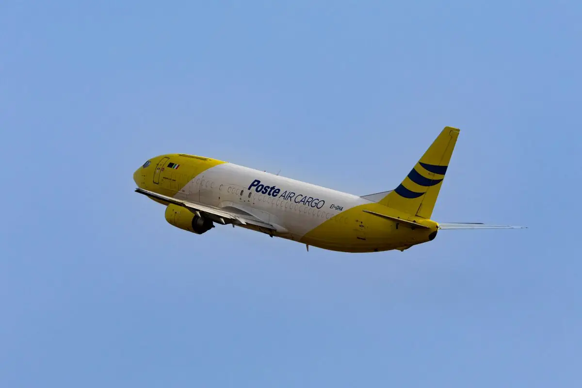 An air cargo freighter aircraft taking off from an airport runway